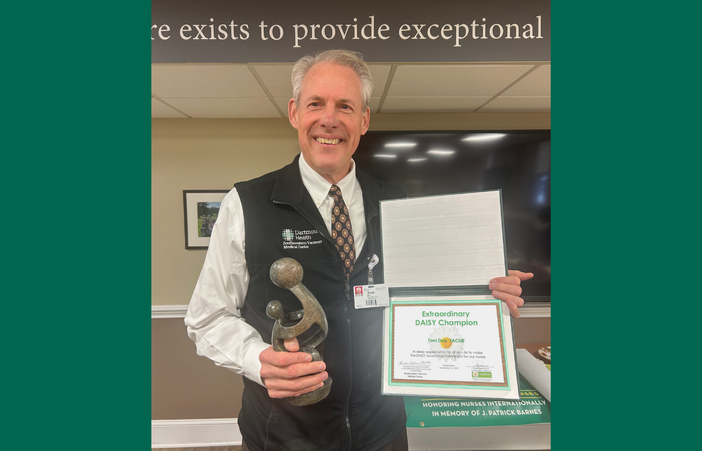 Tom Dee receiving his DAISY Champion Award